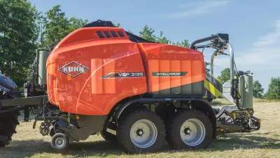 VBP 3165 baler wrapper combination baling and wrapping bales under a blue sky.