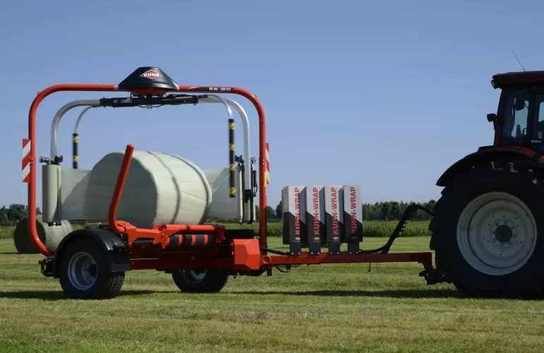 RW 1800 round bale wrapper wrapping bales in a field.