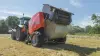 KUHN FB 3135 AUTOMATE ejecting a round bale bound with film.